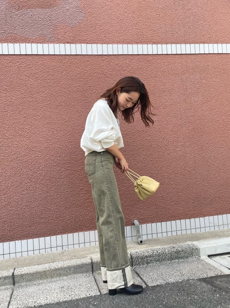 ベージュ系のデニムパンツ、ホワイト系のスウェットを着用したレディースの秋コーディネートの3枚目の写真
