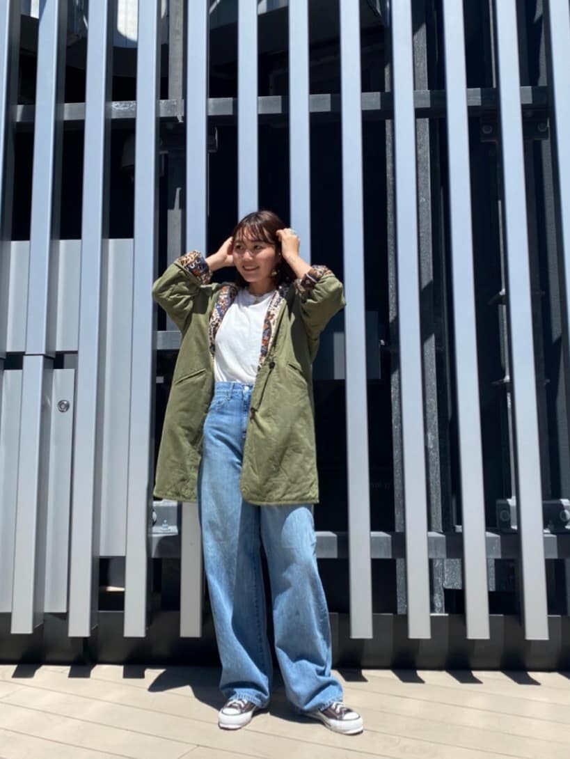 ベージュ系のブルゾン、ブルー系のデニムパンツ、ホワイト系のTシャツ/カットソーを着用したレディースの夏コーディネートの2枚目の写真