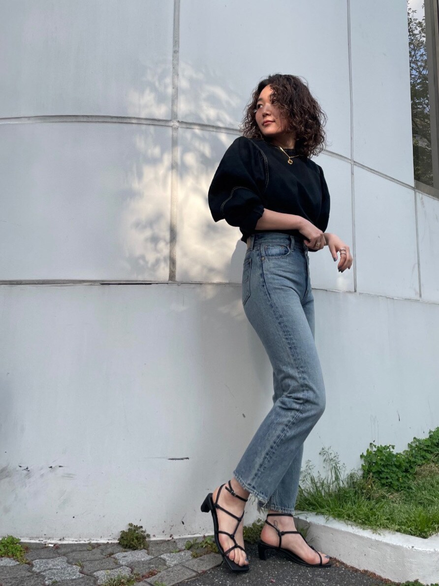 ブラック系のシャツ/ブラウス、ブルー系のデニムパンツ、ブラック系のサンダルを着用したレディースの春コーディネートの2枚目の写真