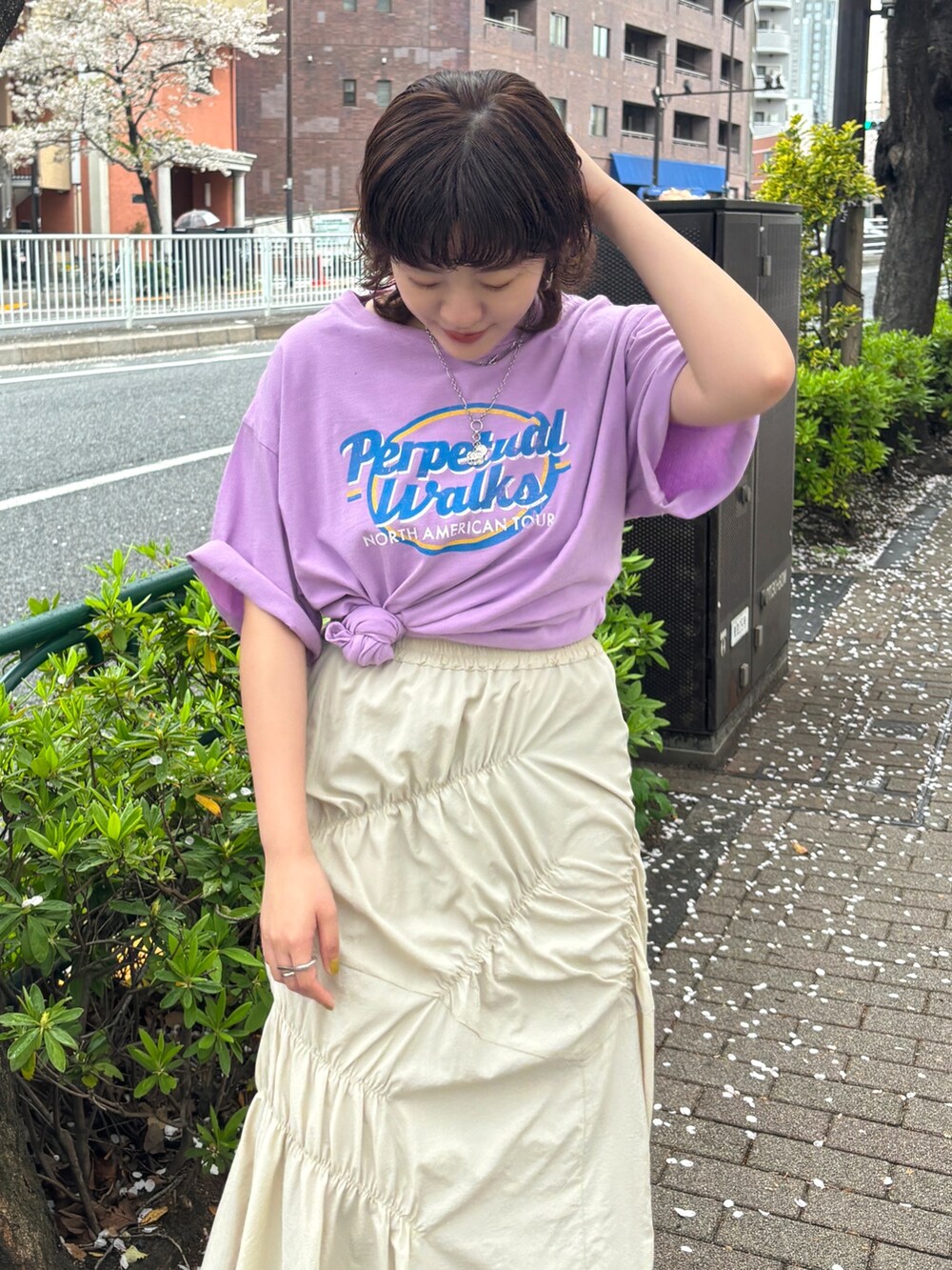 パープル系のTシャツ/カットソー、ホワイト系のスカートを着用したレディースの春コーディネートの6枚目の写真