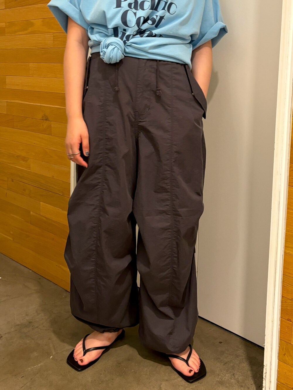 ブルー系のTシャツ/カットソー、グレー系のその他パンツ、ブラック系のサンダルを着用したレディースの春コーディネートの6枚目の写真