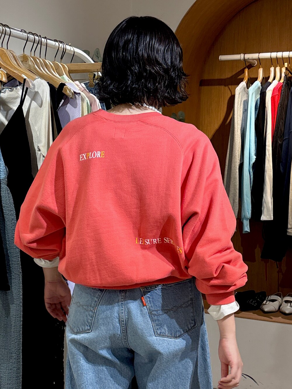 ブルー系のデニムパンツ、レッド系のスウェットを着用したレディースの冬コーディネートの4枚目の写真