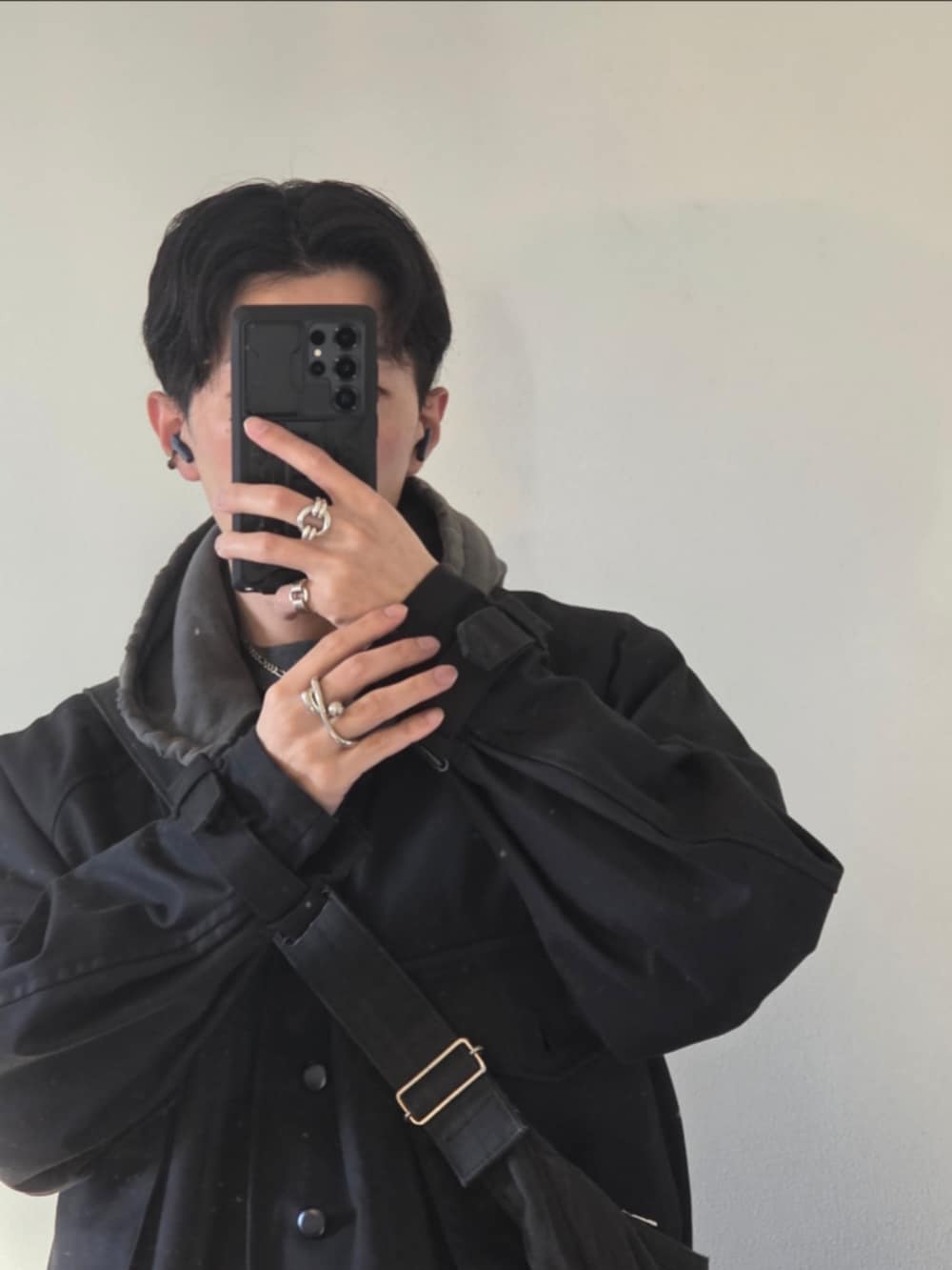 ブラック系のデニムパンツ、ブラック系のテーラードジャケット、ブラック系のショルダーバッグを着用したメンズの秋コーディネートの2枚目の写真