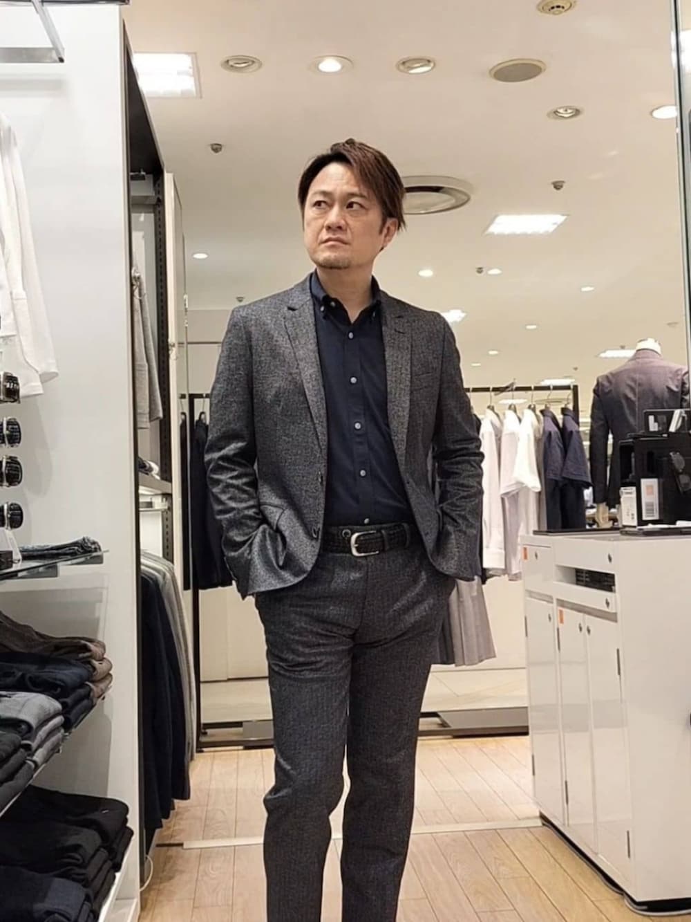ブラック系のその他アウター、ブラック系のスーツパンツ、ブルー系のシャツ/ブラウスを着用したメンズの秋コーディネートの2枚目の写真