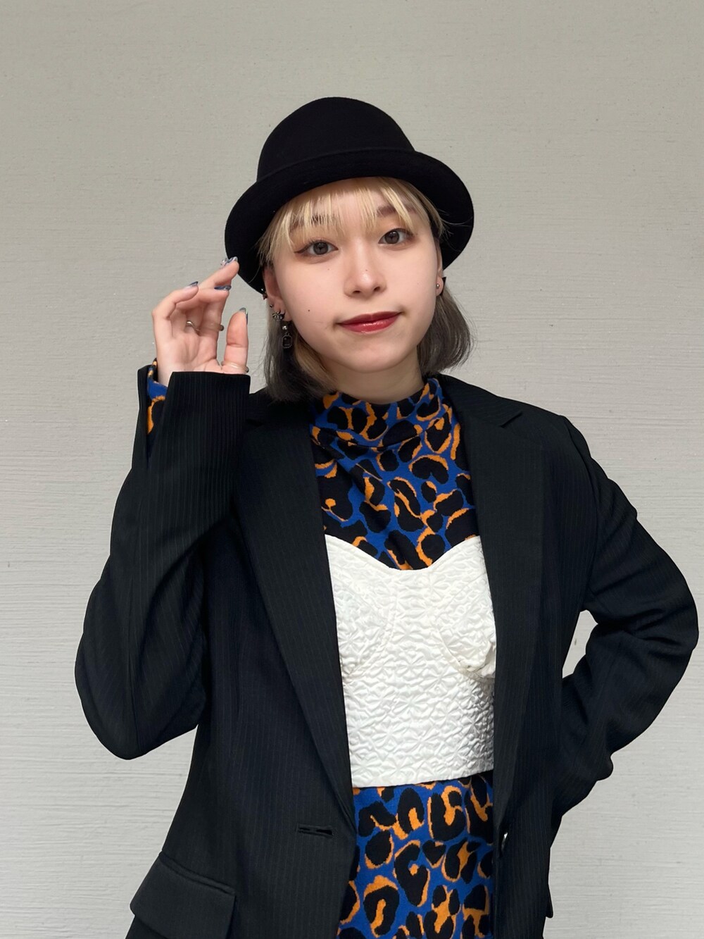 ブラック系のハットを着用したレディースの春コーディネートの2枚目の写真