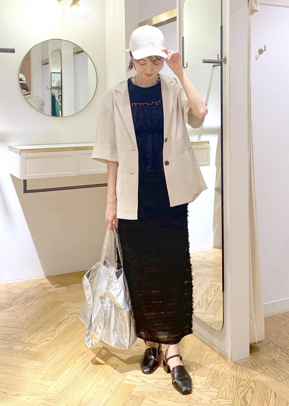 ブラック系のサンダル、ブラック系のスカート、ブラック系のキャミソールを着用したレディースの春コーディネートの5枚目の写真