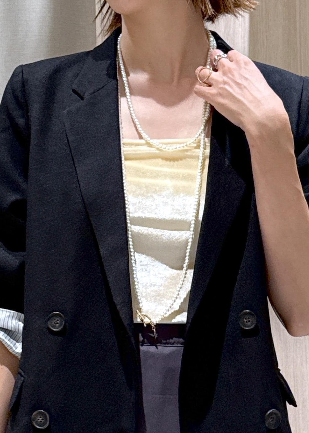 ブラック系のパンプス、ブラック系のテーラードジャケット、ベージュ系のショルダーバッグを着用したレディースの秋コーディネートの10枚目の写真