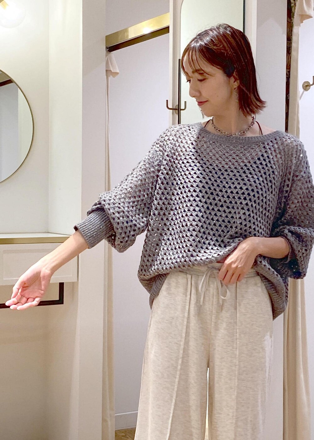 ホワイト系のその他パンツ、グレー系のニット/セーター、ブラック系のハンドバッグを着用したレディースの秋コーディネートの4枚目の写真