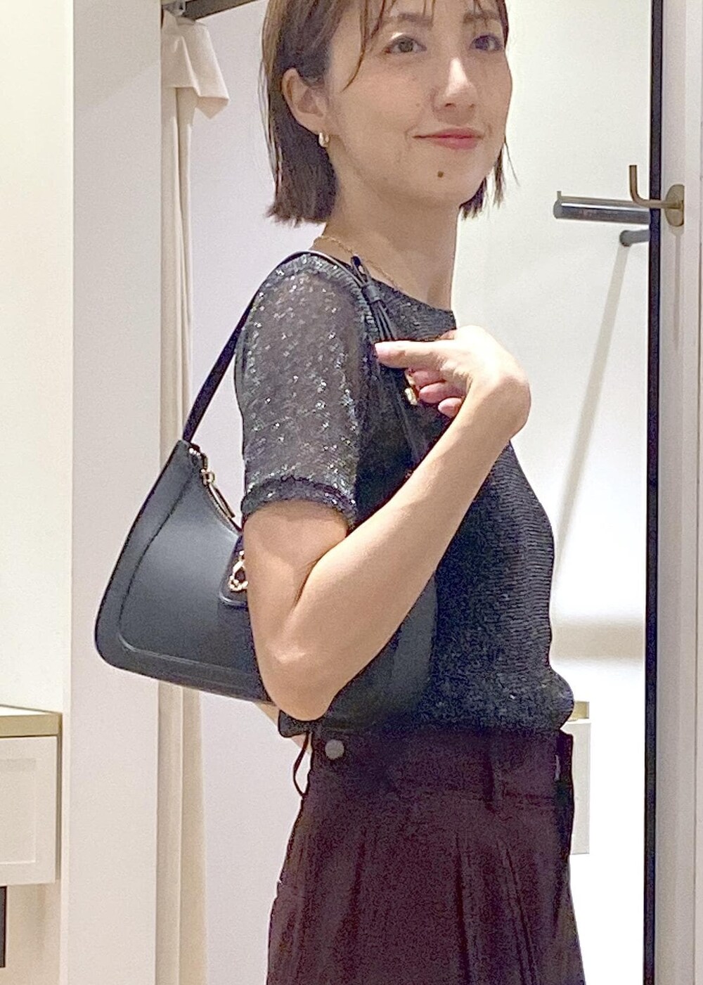 ブラック系のハンドバッグ、ブラック系のキャミソール、ブラック系のTシャツ/カットソーを着用したレディースの夏コーディネートの6枚目の写真