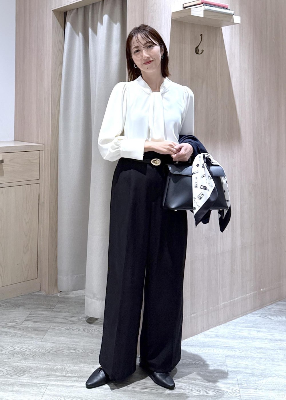 ブラック系のハンドバッグ、ブラック系のその他パンツ、ブラック系のパンプスを着用したレディースの秋コーディネートの3枚目の写真