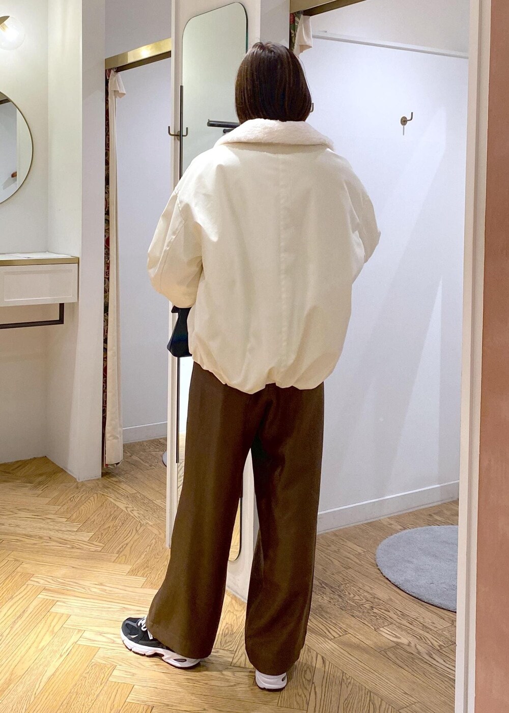 ホワイト系のブルゾン、ホワイト系のニット/セーター、ブラウン系のその他パンツを着用したレディースの冬コーディネートの4枚目の写真