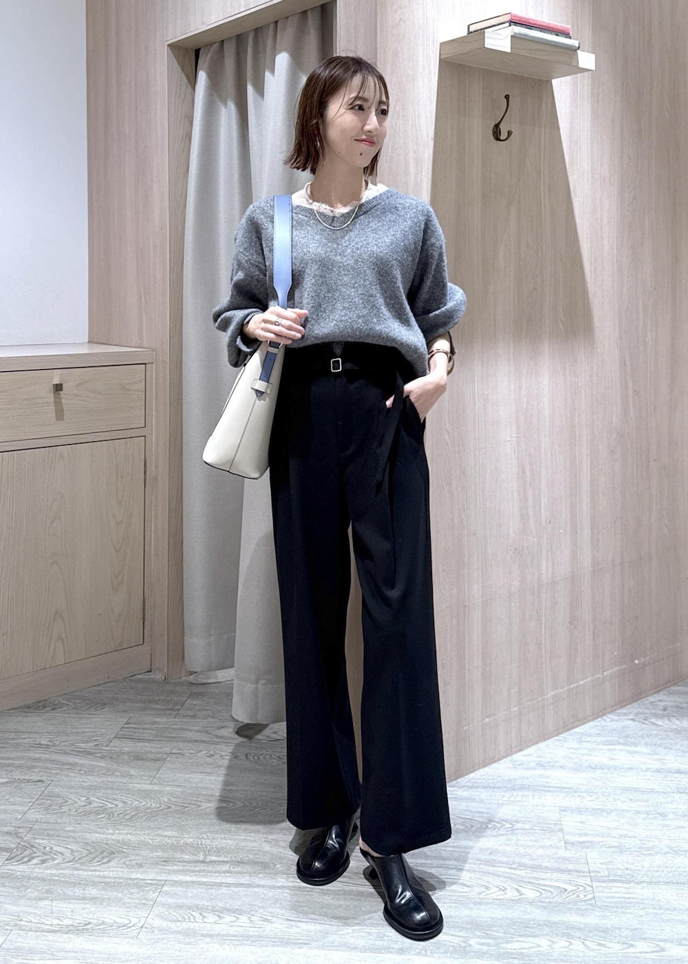 グレー系のニット/セーター、グレー系のその他アウター、ブラック系のその他パンツを着用したレディースの冬コーディネートの6枚目の写真
