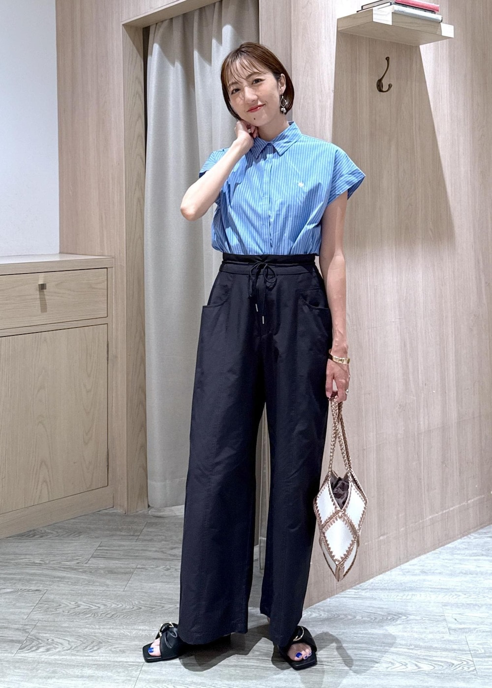 ブラック系のサンダル、ブラック系のキャミソール、ブルー系のシャツ/ブラウスを着用したレディースの夏コーディネートの5枚目の写真