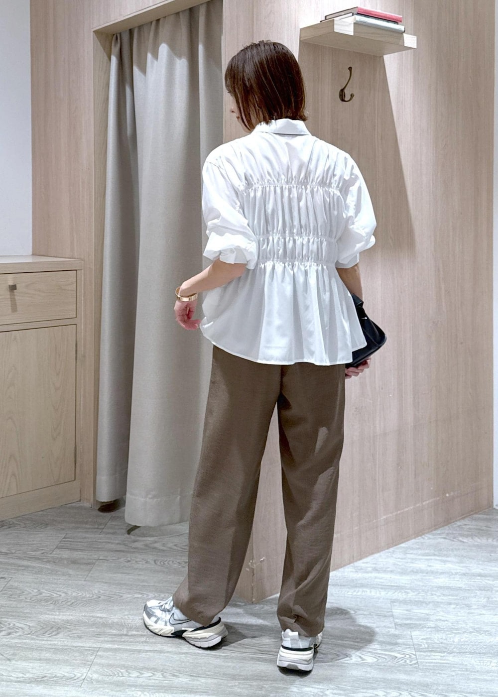 ホワイト系のシャツ/ブラウス、ブラック系のショルダーバッグ、グリーン系のスラックスを着用したレディースの春コーディネートの3枚目の写真