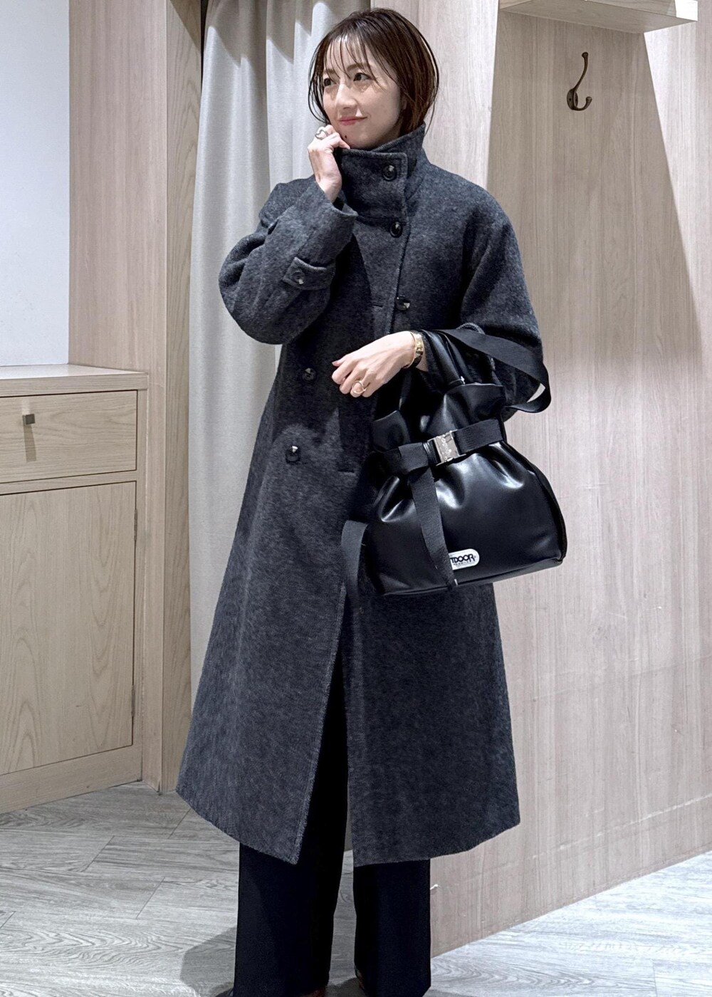 ブラック系のスラックス、グレー系のその他アウター、ブルー系のシャツ/ブラウスを着用したレディースの冬コーディネートの5枚目の写真