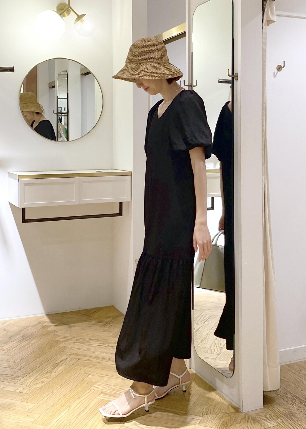 ブラック系のキャミソール、ホワイト系のサンダル、ホワイト系のハンドバッグを着用したレディースの春コーディネートの4枚目の写真