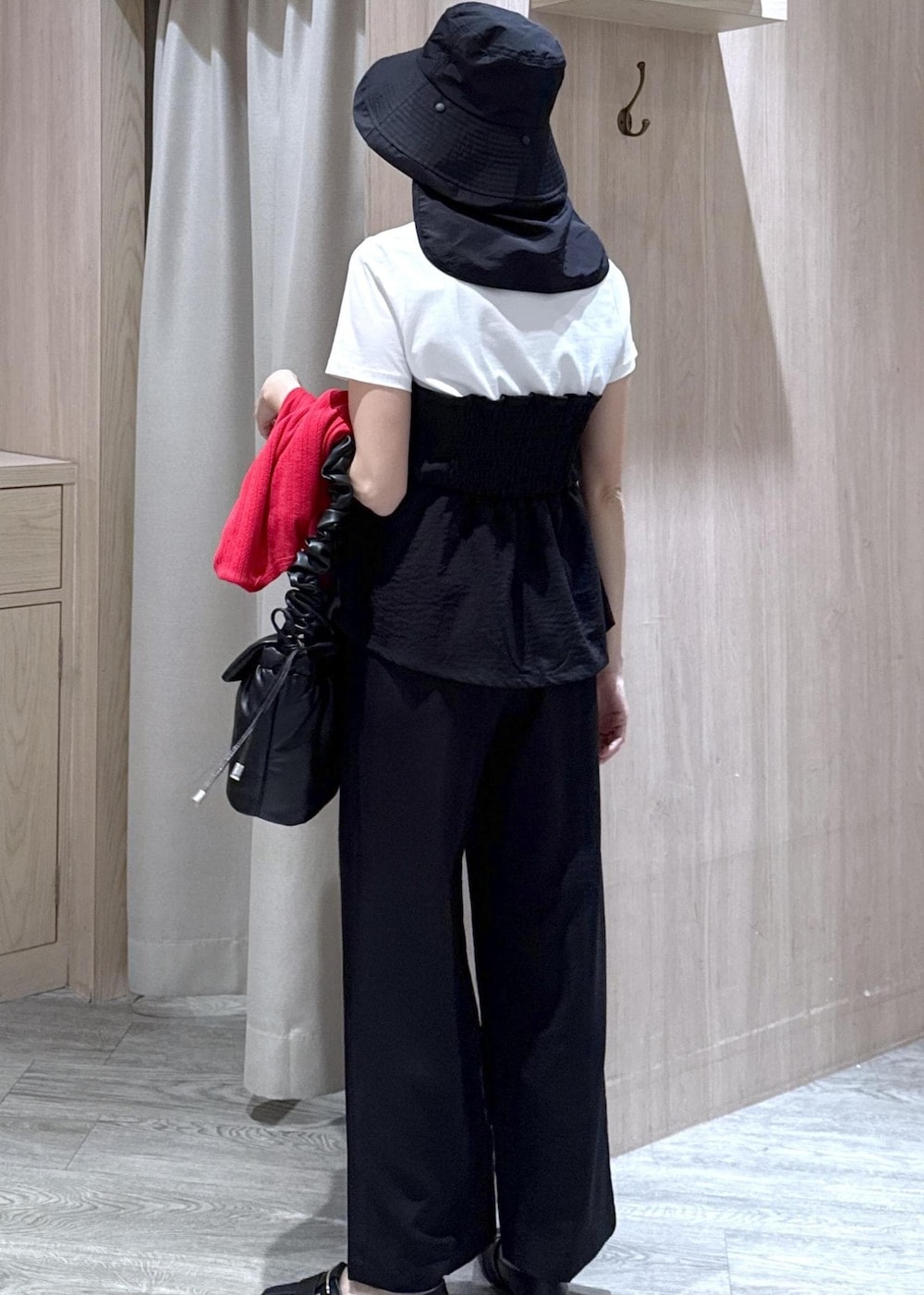 ブラック系のショルダーバッグ、ブラック系のパンプス、レッド系のカーディガン/ボレロを着用したレディースの春コーディネートの4枚目の写真