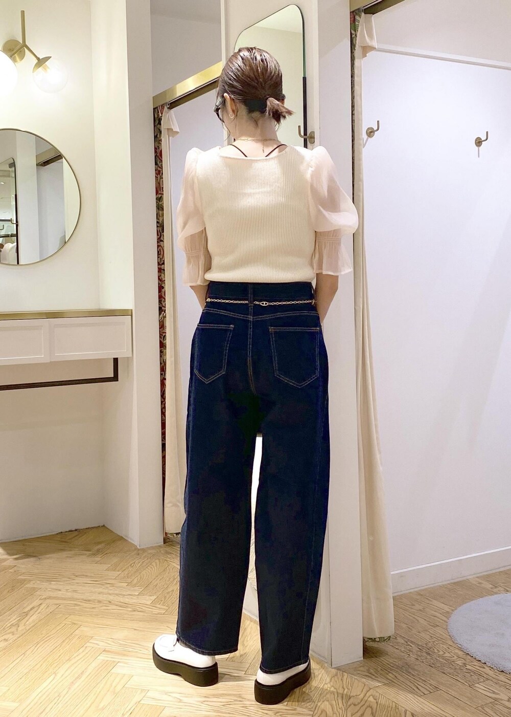 ホワイト系のローファー、ブラック系のショルダーバッグ、ブルー系のデニムパンツを着用したレディースの春コーディネートの2枚目の写真