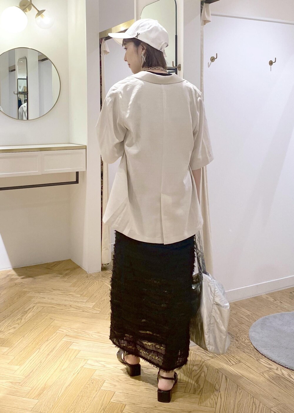 ブラック系のサンダル、ブラック系のスカート、ブラック系のキャミソールを着用したレディースの春コーディネートの4枚目の写真