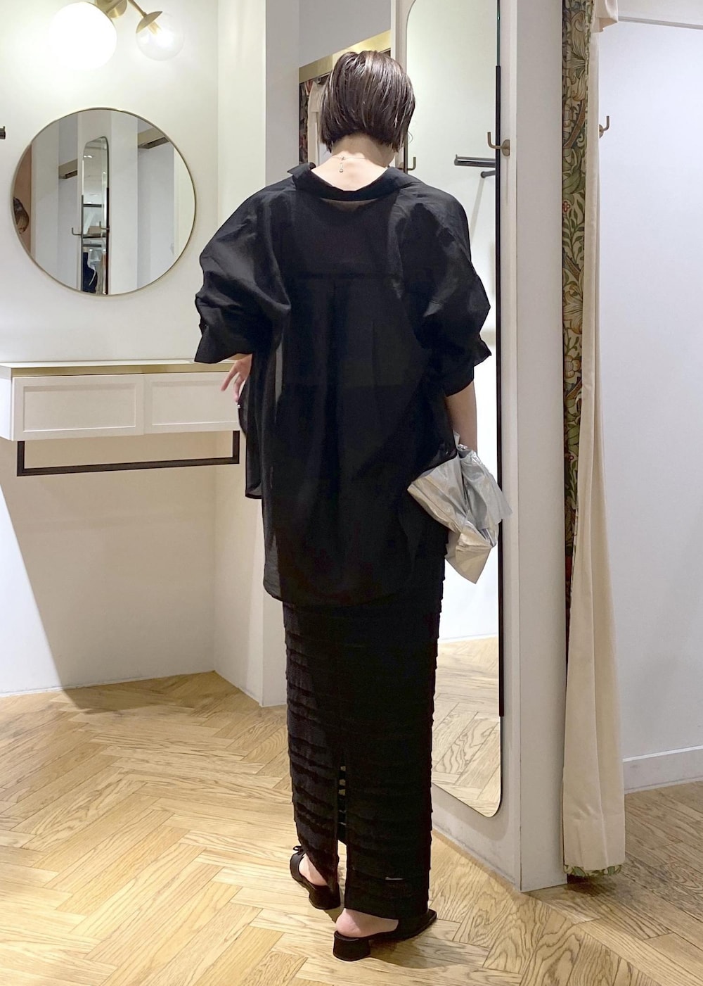 ブラック系のサンダル、ブラック系のスカート、シルバー系のキャミソールを着用したレディースの夏コーディネートの2枚目の写真