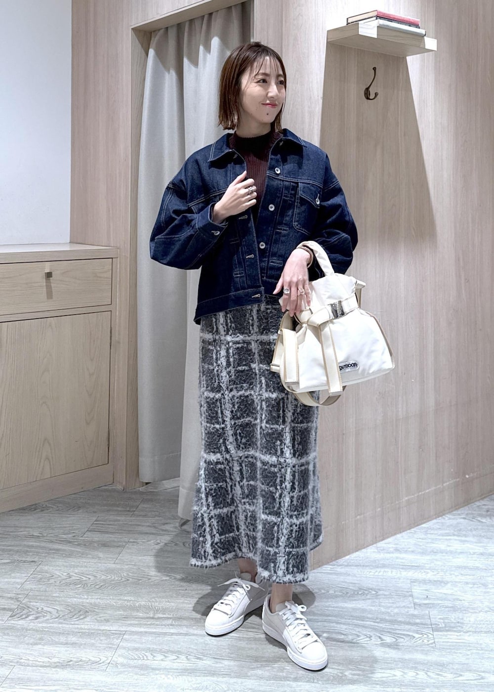 グレー系のスニーカー、グレー系のスカート、ブラウン系のニット/セーターを着用したレディースの冬コーディネートの5枚目の写真