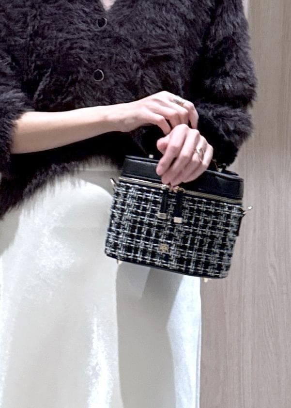 ブラック系のブーツ、ホワイト系のスカート、グレー系のカーディガン/ボレロを着用したレディースの冬コーディネートの9枚目の写真