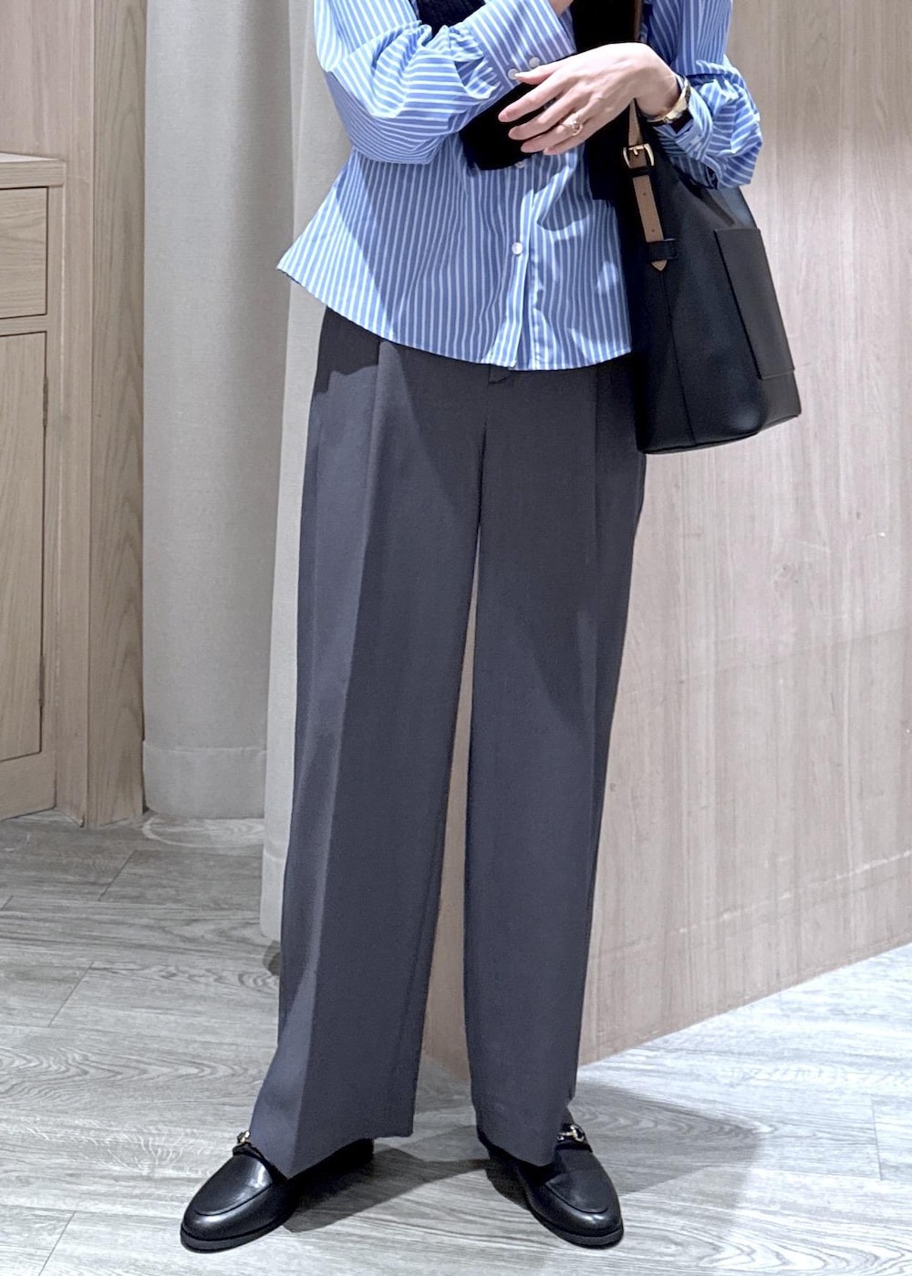 ブラック系のトートバッグ、ブルー系のカーディガン/ボレロ、グレー系のその他パンツを着用したレディースの冬コーディネートの6枚目の写真