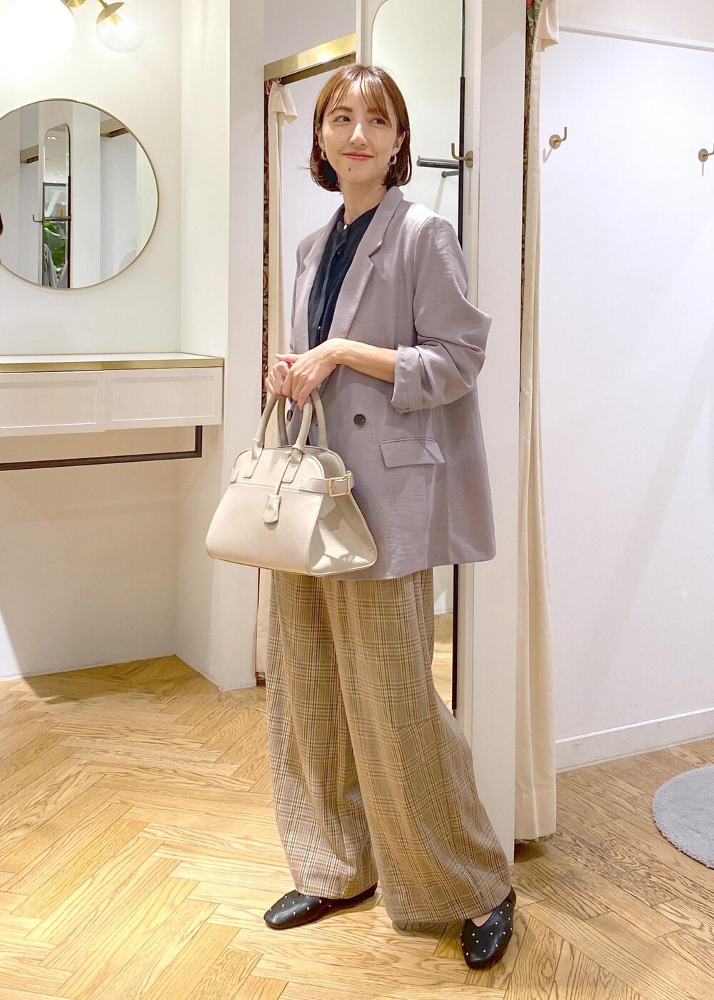 グレー系のテーラードジャケット、ブラック系のバレエシューズ、ベージュ系のトートバッグを着用したレディースの秋コーディネートの8枚目の写真