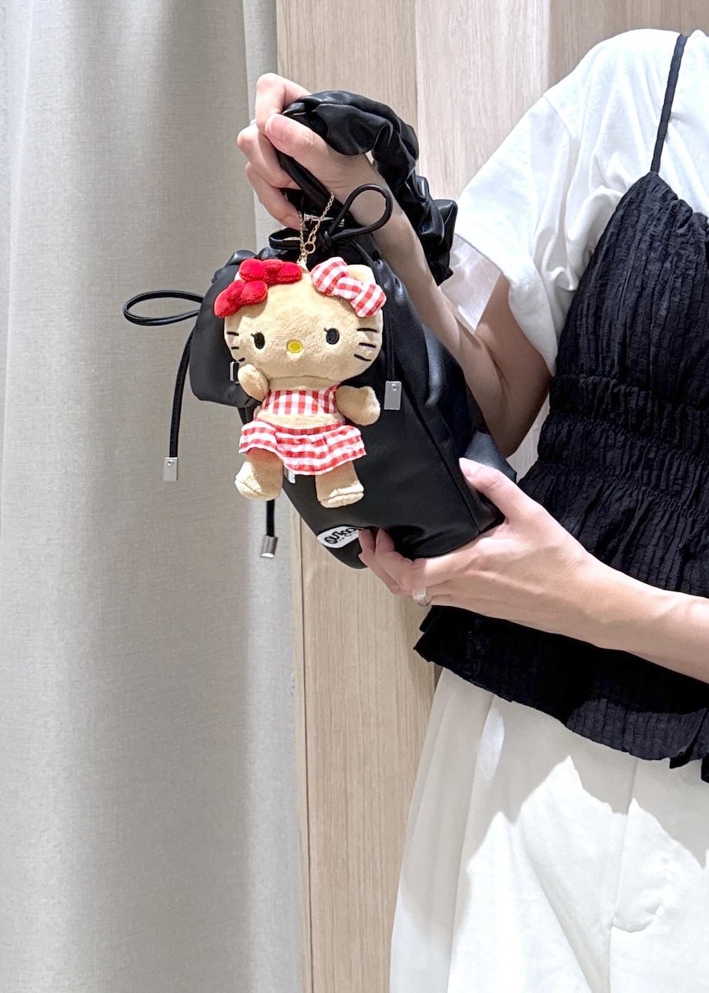 ブラック系のショルダーバッグ、ホワイト系のその他パンツ、ブラック系のパンプスを着用したレディースの夏コーディネートの10枚目の写真