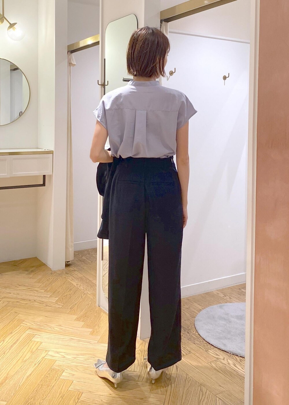 シルバー系のパンプス、ブルー系のスラックス、ブルー系のテーラードジャケットを着用したレディースの夏コーディネートの7枚目の写真