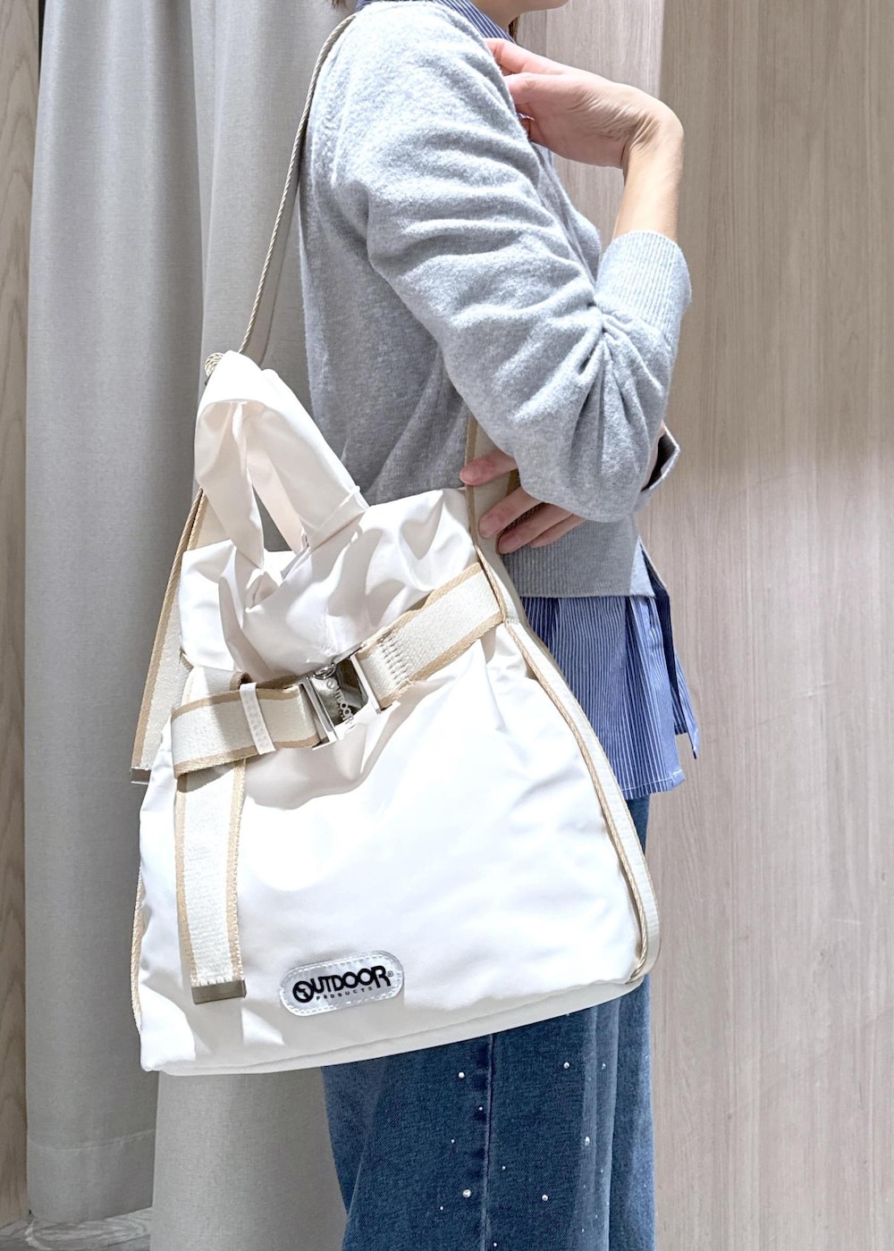 ブルー系のデニムパンツ、グレー系のカーディガン/ボレロ、ホワイト系のトートバッグを着用したレディースの冬コーディネートの8枚目の写真