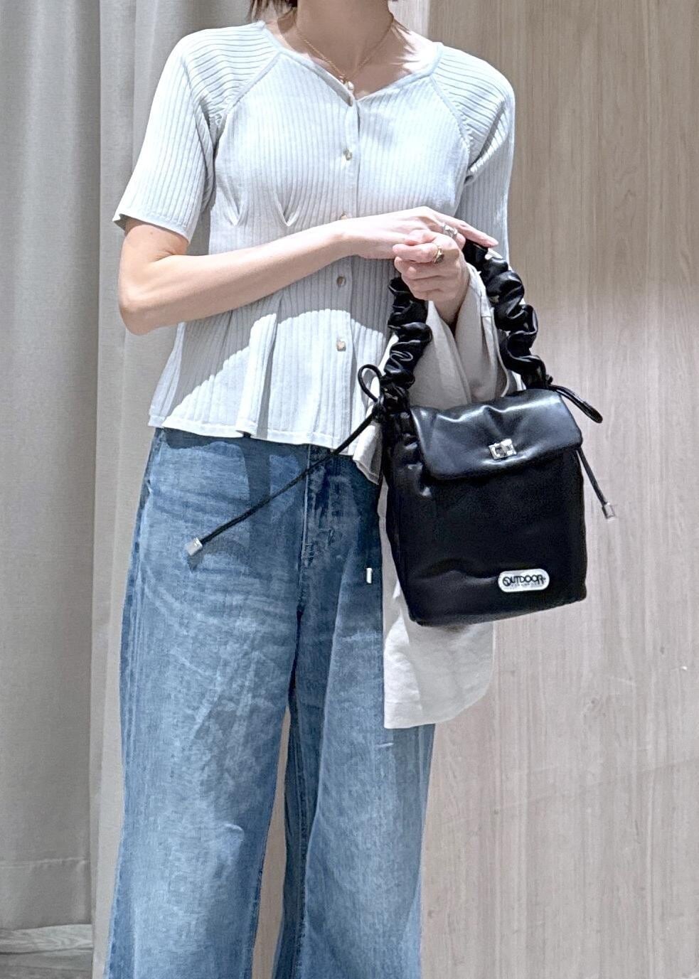 ブルー系のデニムパンツ、ホワイト系のパンプス、ブラック系のショルダーバッグを着用したレディースの春コーディネートの7枚目の写真