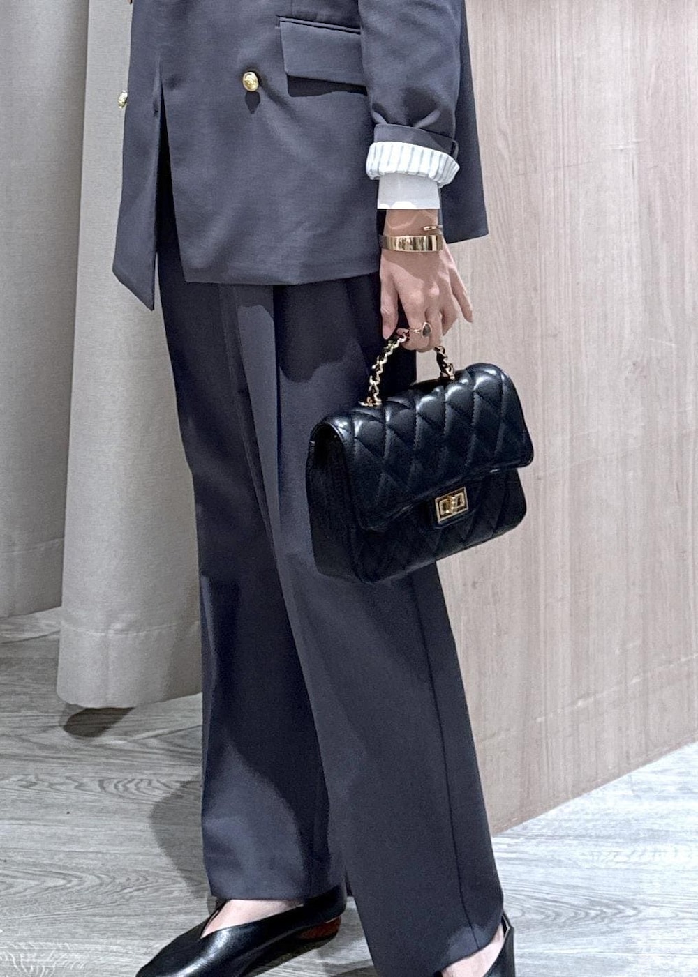 ブラック系のショルダーバッグ、グレー系のその他パンツ、グレー系のテーラードジャケットを着用したレディースの冬コーディネートの5枚目の写真