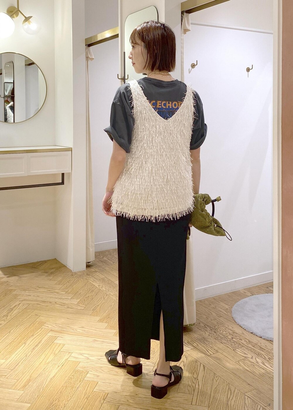 ブラック系のサンダル、ホワイト系のタンクトップ、ゴールド系のショルダーバッグを着用したレディースの夏コーディネートの4枚目の写真