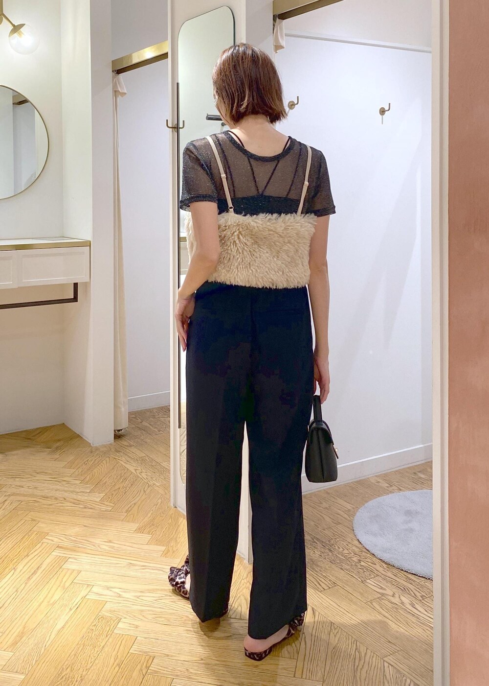 ブラック系のキャミソール、ブラック系のTシャツ/カットソー、ブルー系のスラックスを着用したレディースの夏コーディネートの3枚目の写真