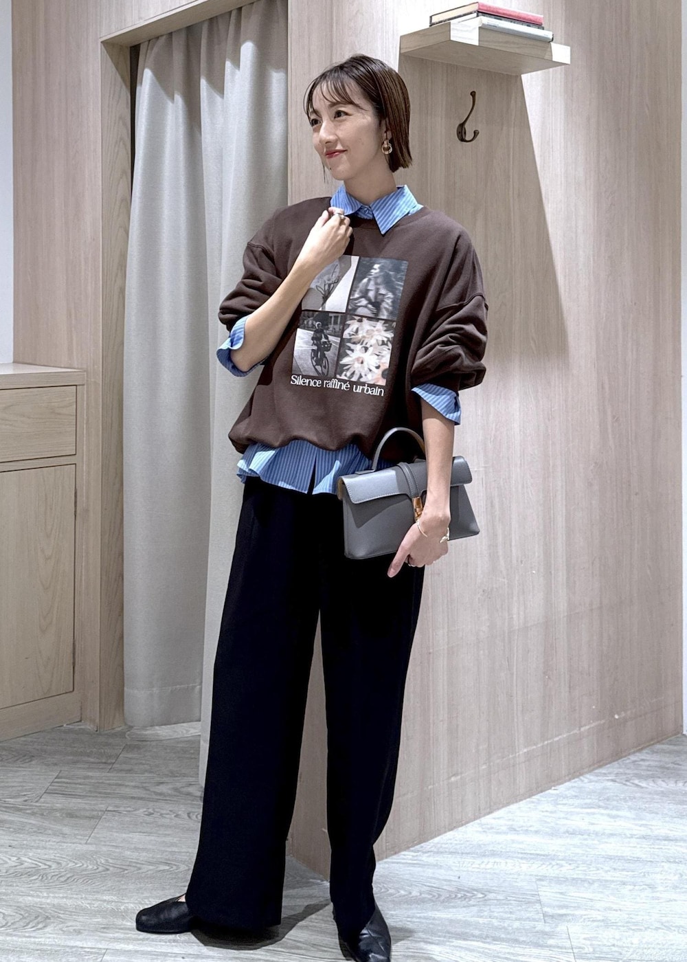 グレー系のショルダーバッグ、ブラック系のスラックス、ブルー系のシャツ/ブラウスを着用したレディースの秋コーディネートの10枚目の写真