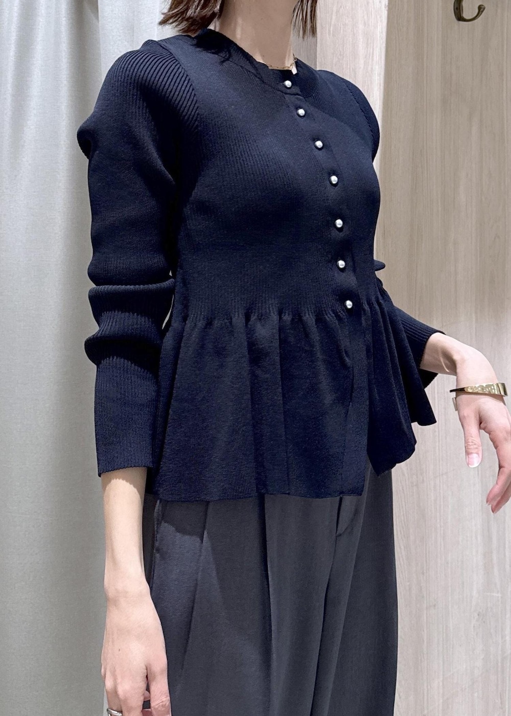 ブラック系のパンプス、グレー系のその他パンツ、ブルー系のカーディガン/ボレロを着用したレディースの冬コーディネートの6枚目の写真