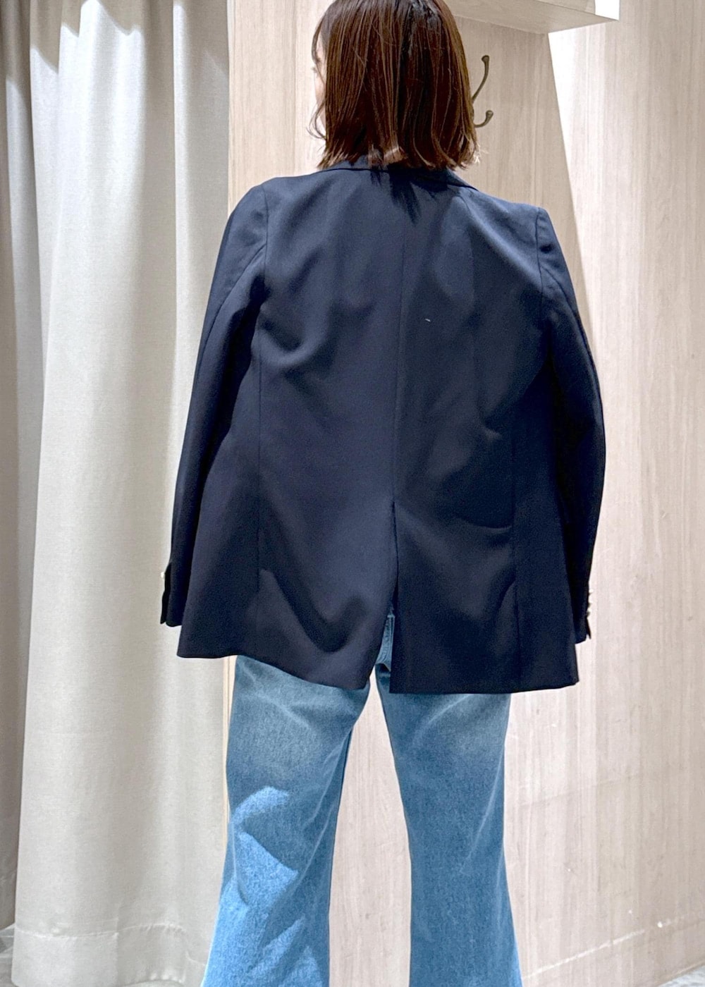 ブラック系のショルダーバッグ、ブルー系のキャミソール、ブルー系のテーラードジャケットを着用したレディースの冬コーディネートの7枚目の写真