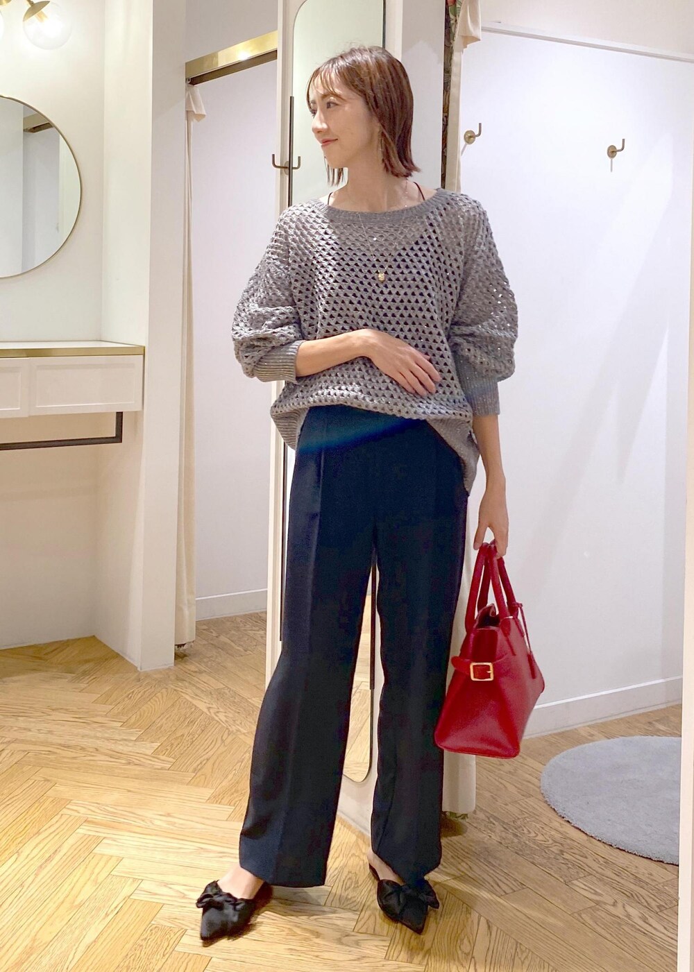 ブルー系のスラックス、ブラック系のサンダル、グレー系のニット/セーターを着用したレディースの秋コーディネートの9枚目の写真