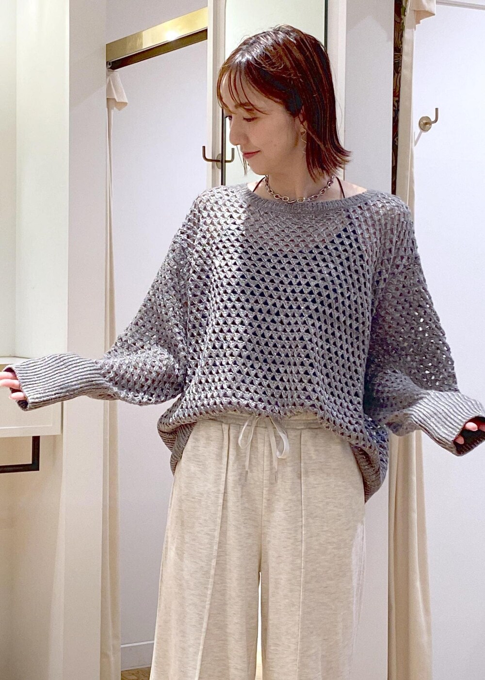 ホワイト系のその他パンツ、グレー系のニット/セーター、ブラック系のハンドバッグを着用したレディースの秋コーディネートの7枚目の写真