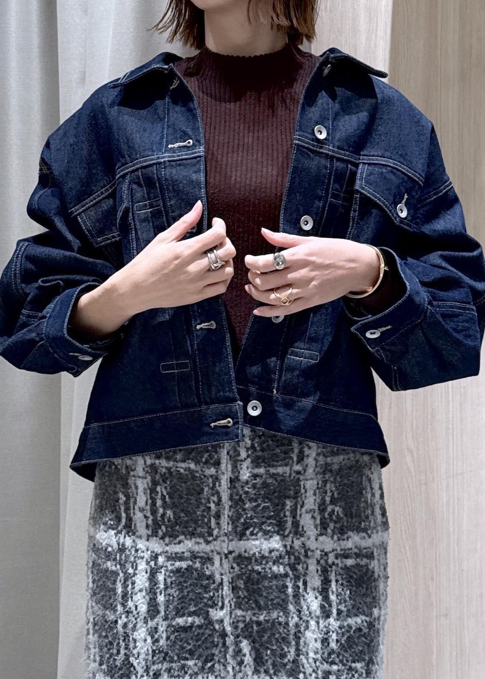 グレー系のスニーカー、グレー系のスカート、ブラウン系のニット/セーターを着用したレディースの冬コーディネートの7枚目の写真