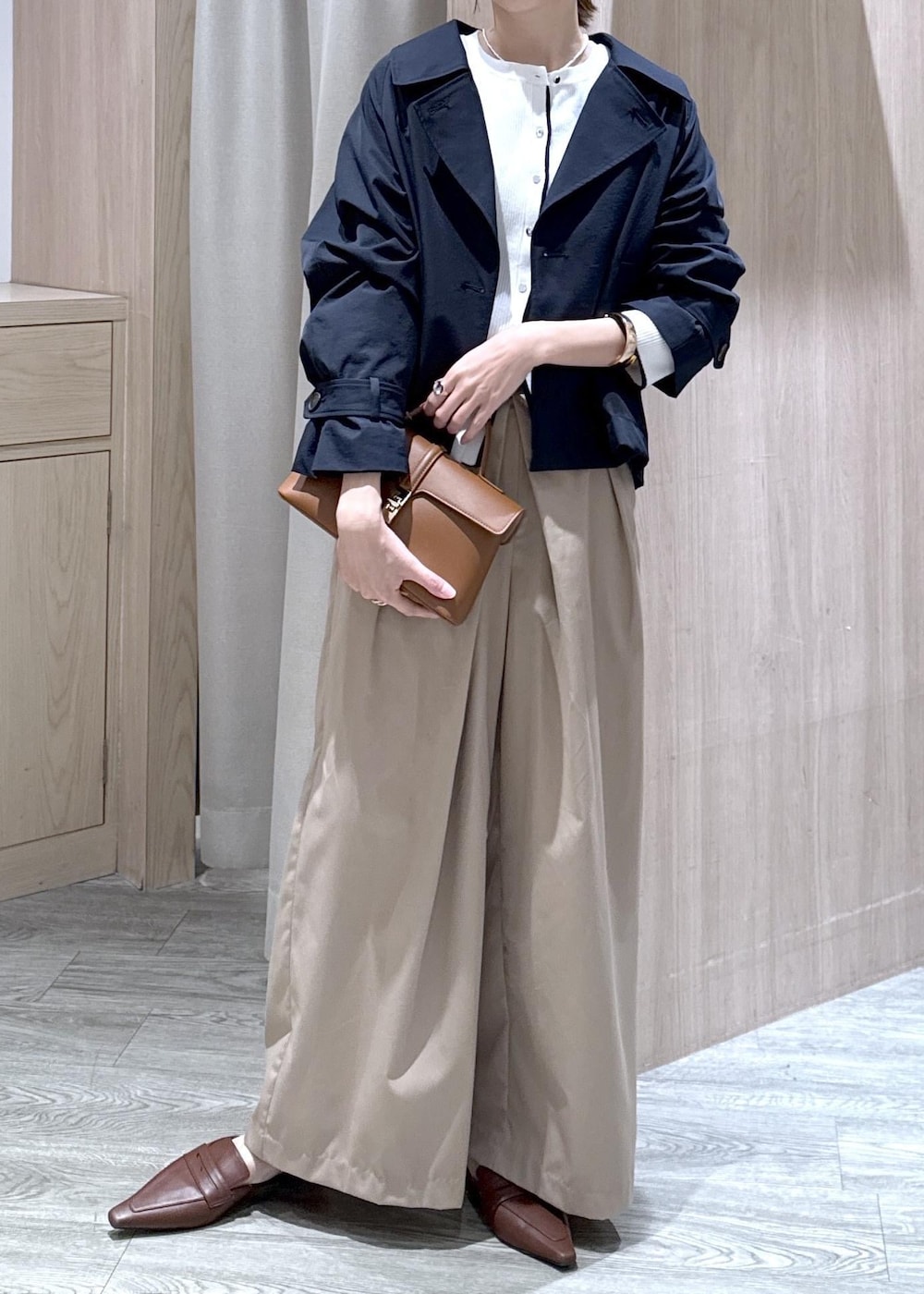 イエロー系のショルダーバッグ、ホワイト系のカーディガン/ボレロ、ベージュ系のその他パンツを着用したレディースの春コーディネートの3枚目の写真