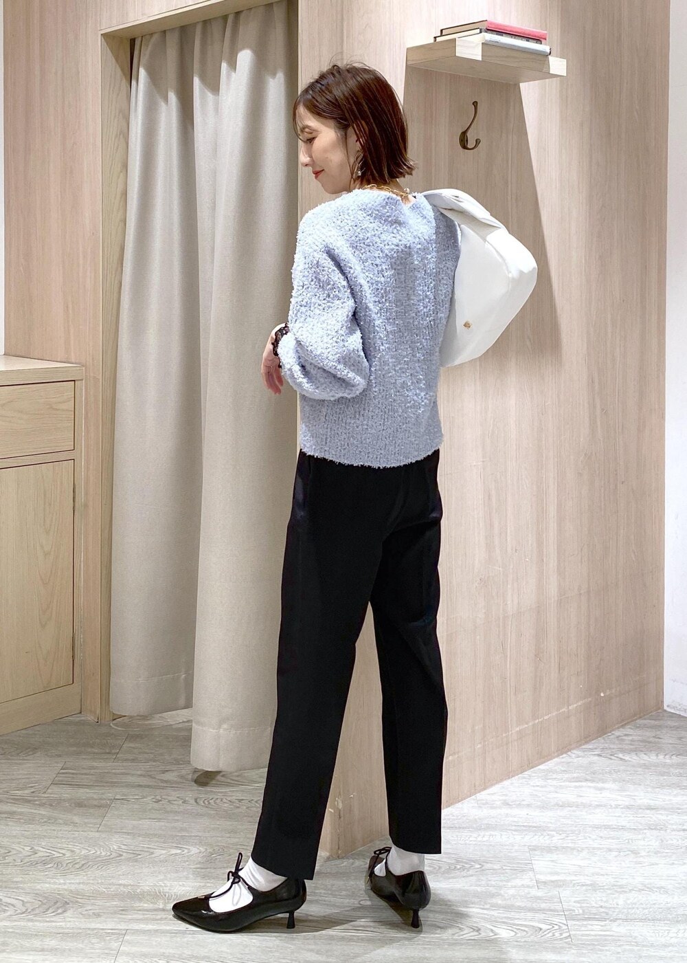 ブラック系のパンプス、ブルー系のカーディガン/ボレロ、ブラック系のTシャツ/カットソーを着用したレディースの冬コーディネートの5枚目の写真