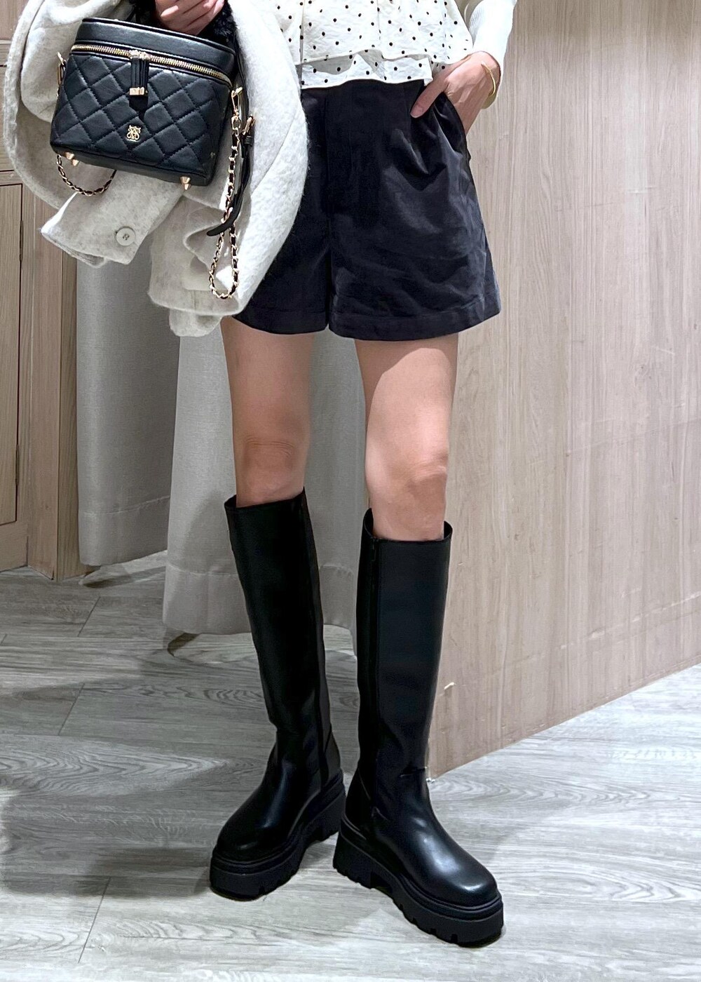 ブラック系のブーツ、ホワイト系のブルゾン、ホワイト系のニット/セーターを着用したレディースの秋コーディネートの9枚目の写真