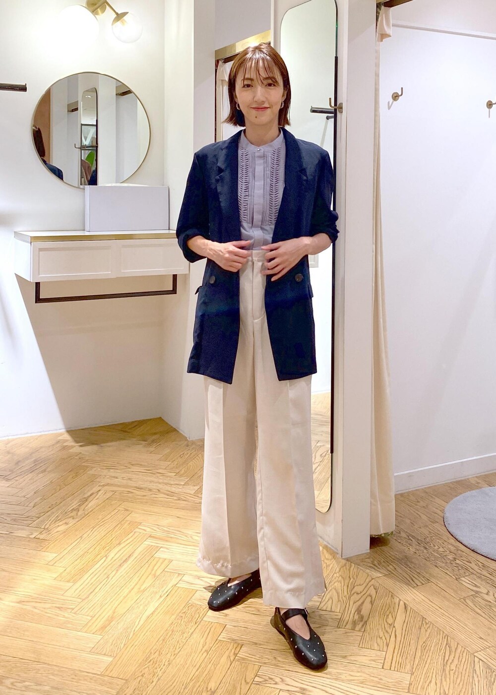 ブルー系のテーラードジャケット、ブルー系のシャツ/ブラウス、ホワイト系のスラックスを着用したレディースの夏コーディネートの5枚目の写真