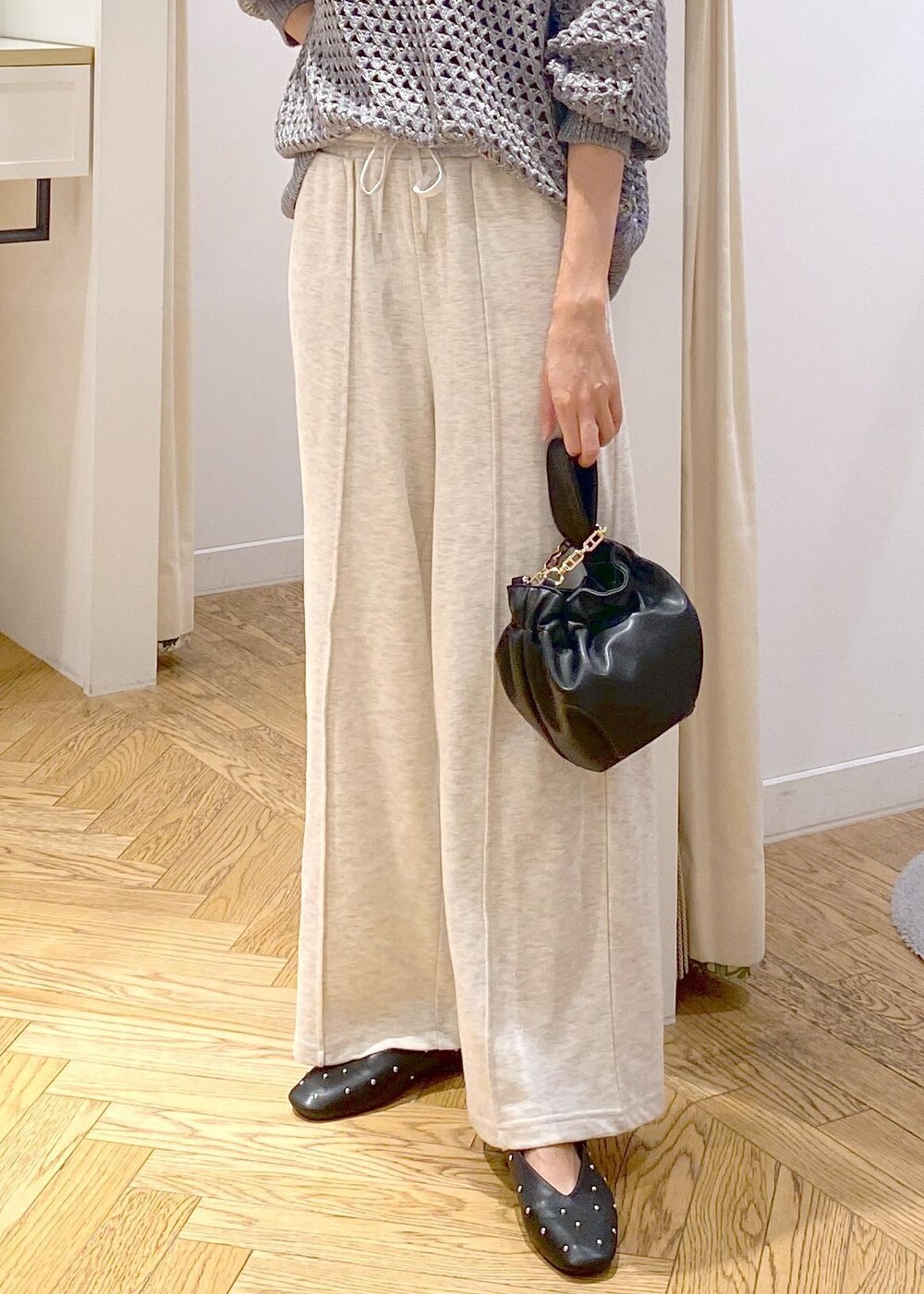 ホワイト系のその他パンツ、グレー系のニット/セーター、ブラック系のハンドバッグを着用したレディースの秋コーディネートの8枚目の写真