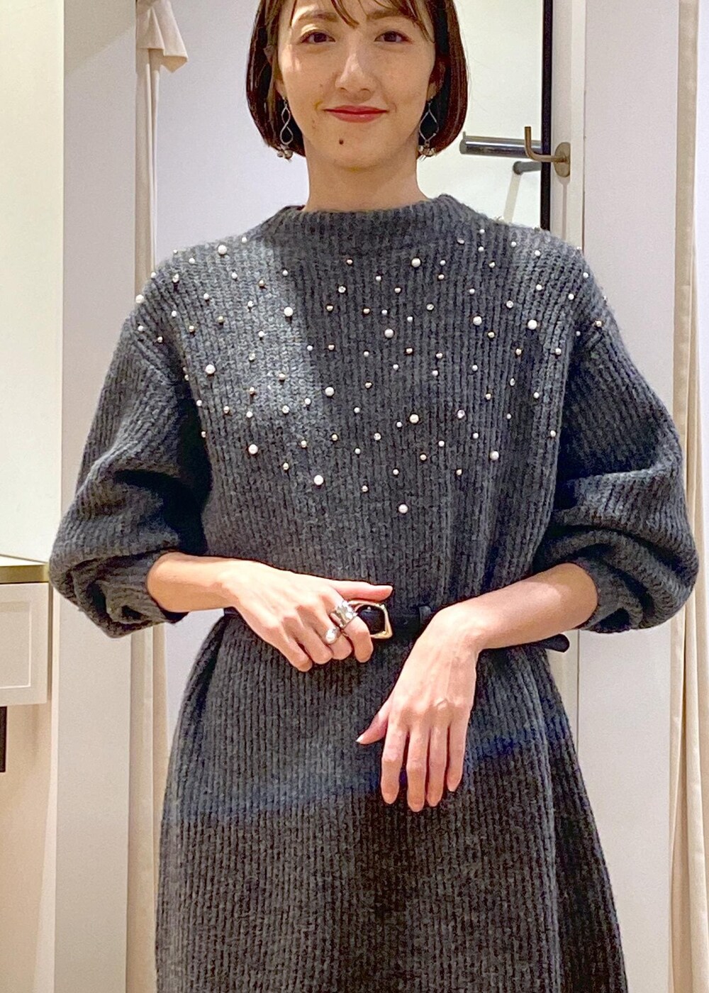 ホワイト系のブーツ、ブラウン系のスカート、グレー系のワンピースを着用したレディースの冬コーディネートの5枚目の写真