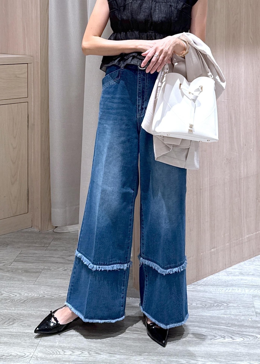 ホワイト系のショルダーバッグ、ブラック系のパンプス、ブラック系のTシャツ/カットソーを着用したレディースの夏コーディネートの5枚目の写真