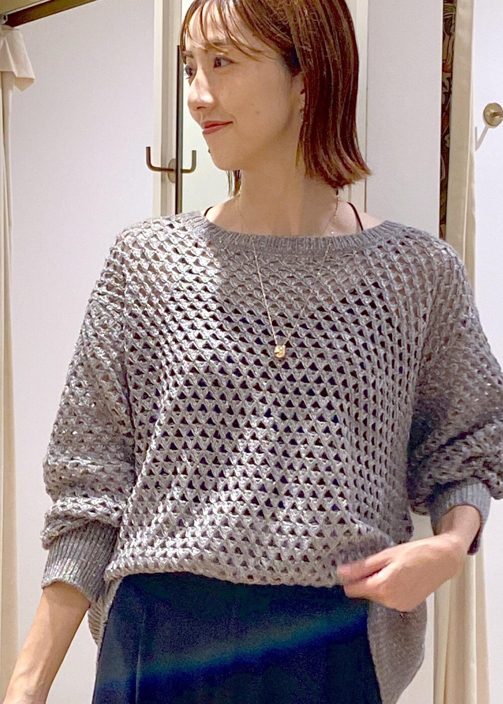 ブルー系のスラックス、ブラック系のサンダル、グレー系のニット/セーターを着用したレディースの秋コーディネートの6枚目の写真