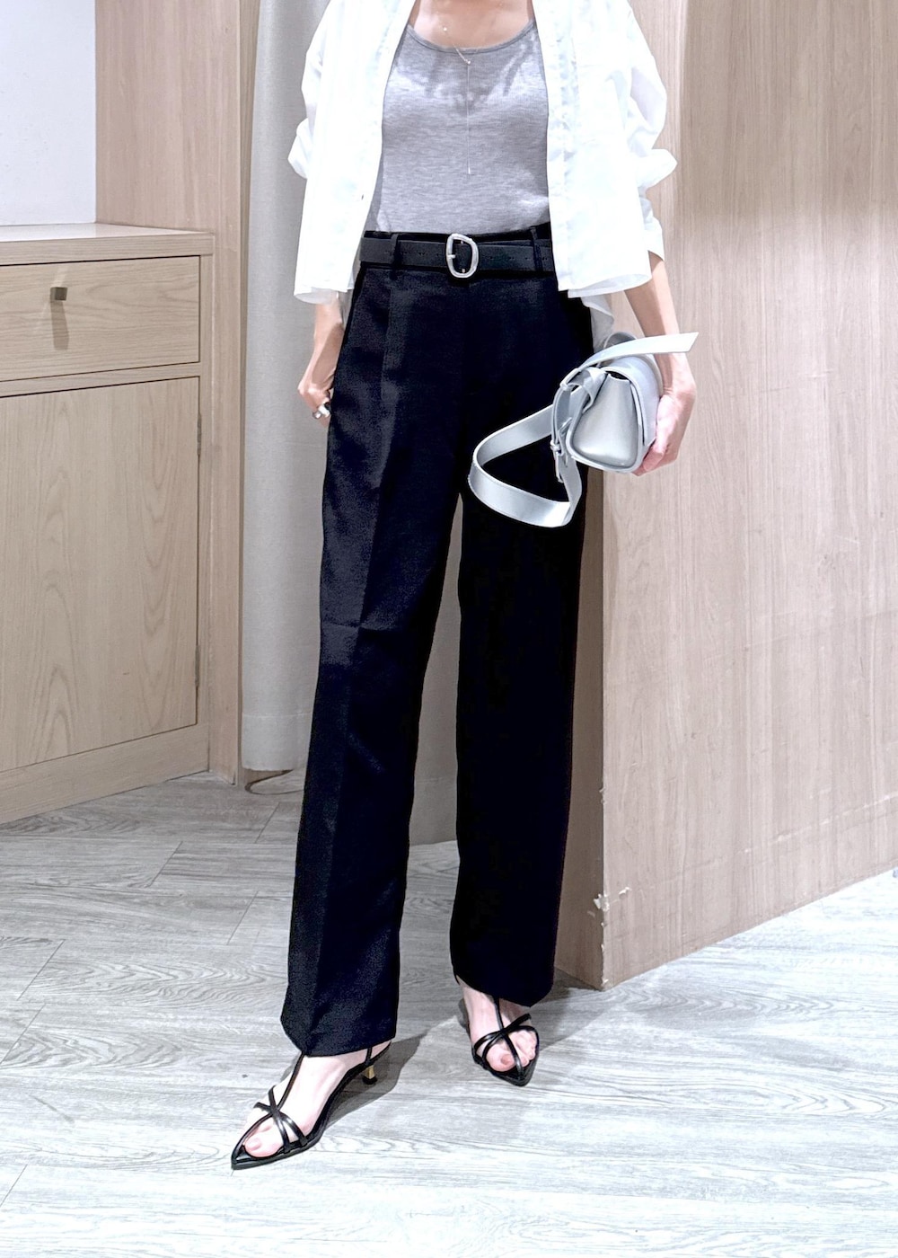 グレー系のタンクトップ、シルバー系のショルダーバッグ、ブラック系のサンダルを着用したレディースの春コーディネートの5枚目の写真